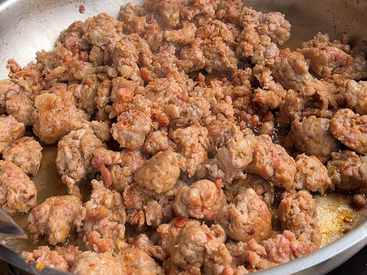 browning pork sausages in pan