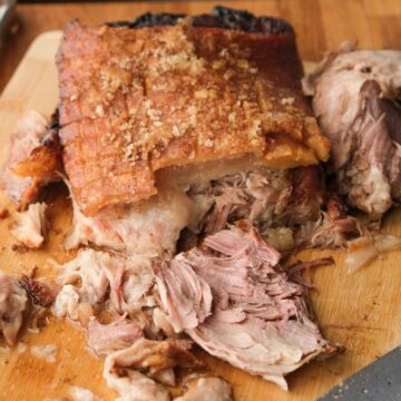 Beer braised pork shoulder pulled apart with crispy golden crackling on top