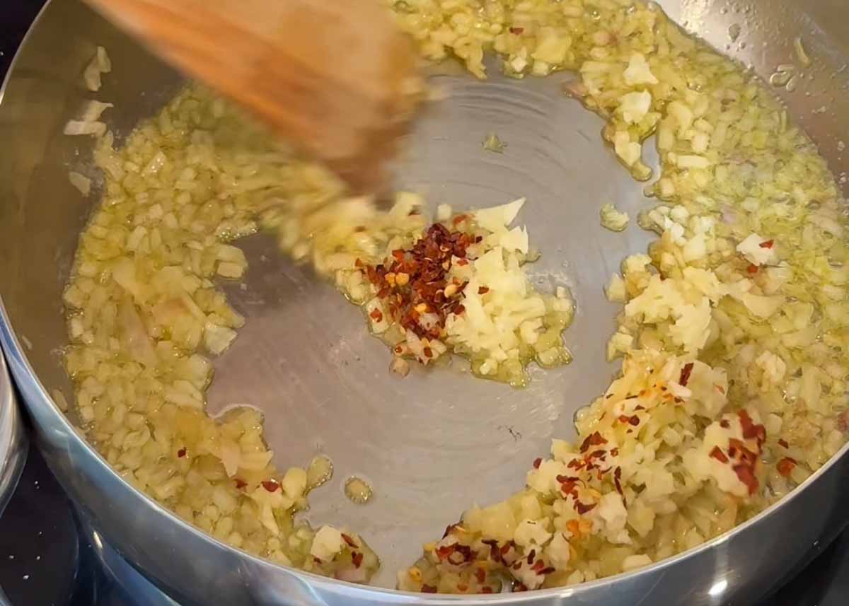 Garlic and chilli cooking in olive oil as base for saffron prawn orzo