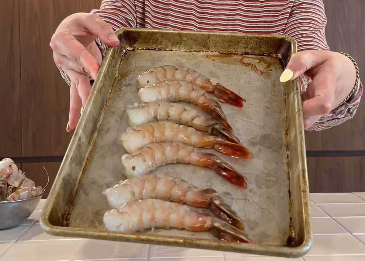 Raw king prawns prepared on tray before cooking for prawn orzo
