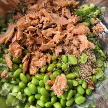 Salmon, edamame and cucumber salad with chilli crisp served in a bowl (feature image)