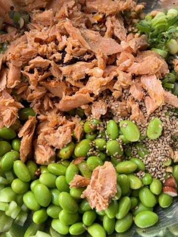 Salmon, edamame and cucumber salad with chilli crisp served in a bowl (feature image)