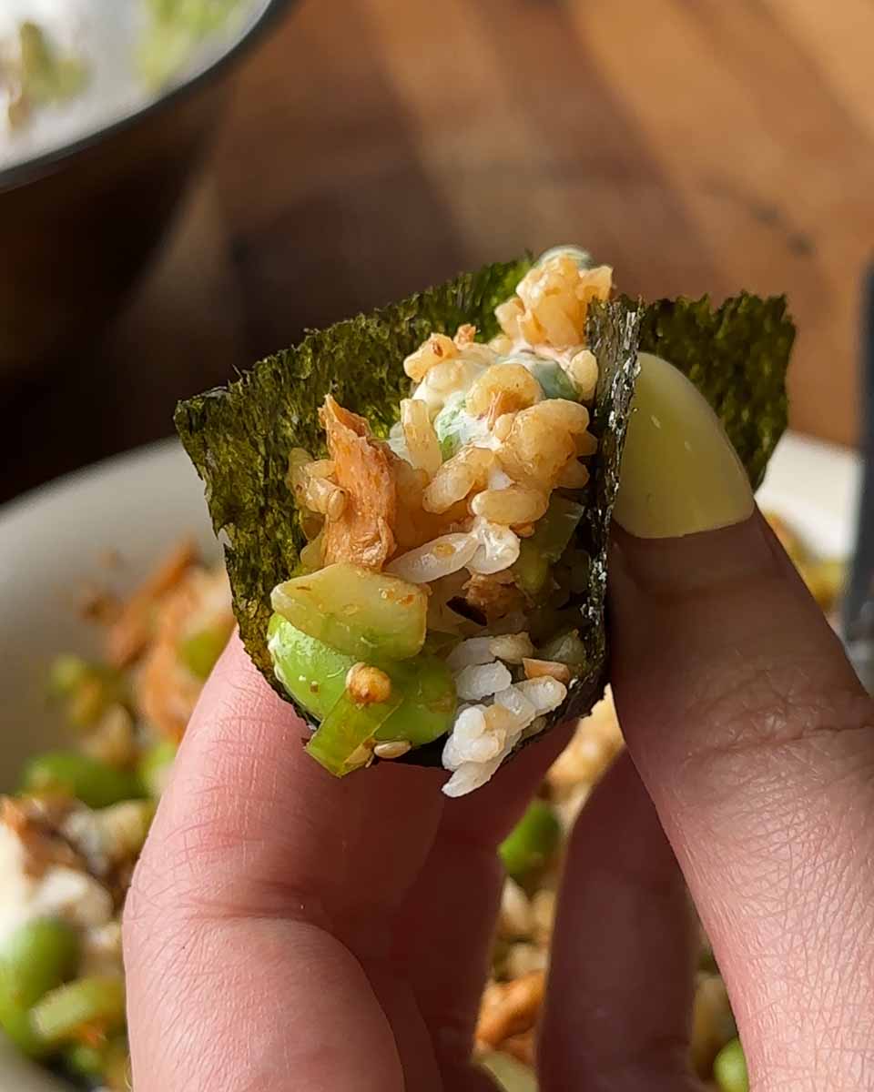 Seaweed sheet scooping salmon edamame cucumber salad with chilli crisp
