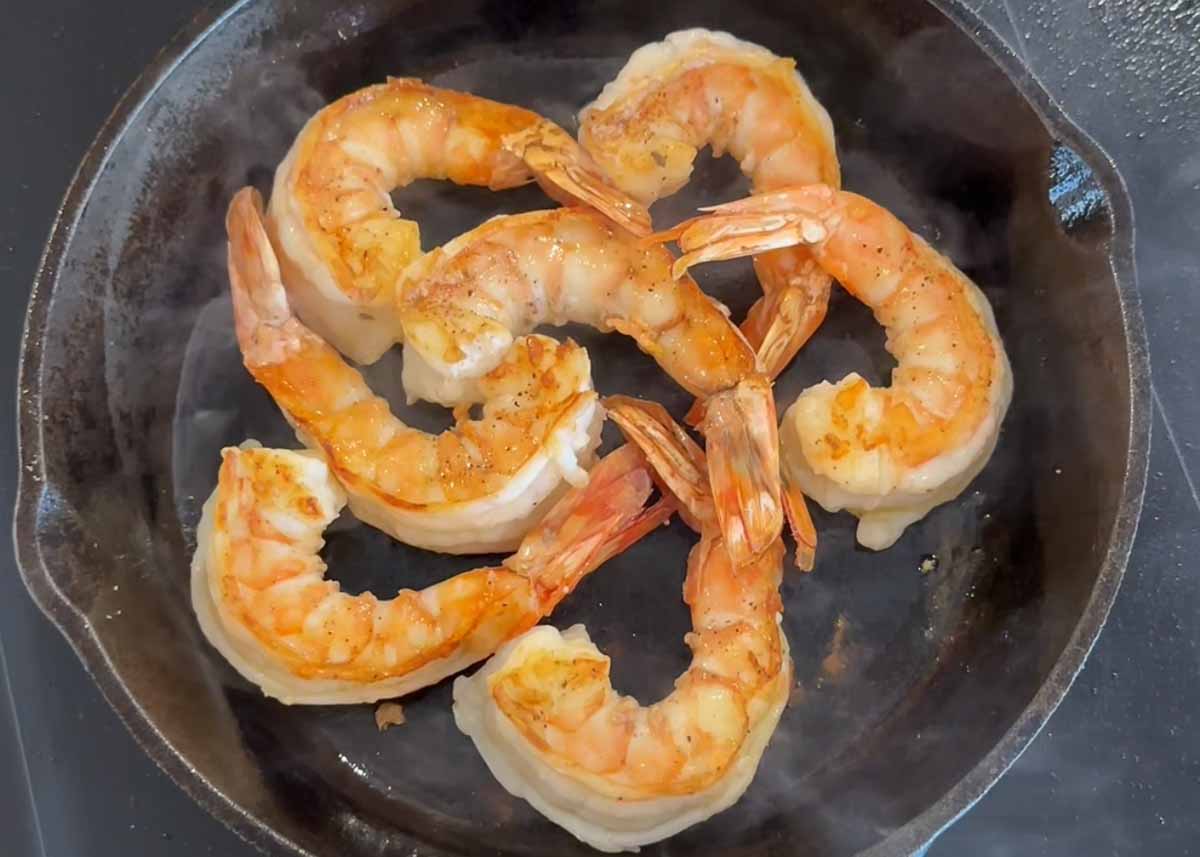 King prawns searing in a hot pan until golden and caramelised