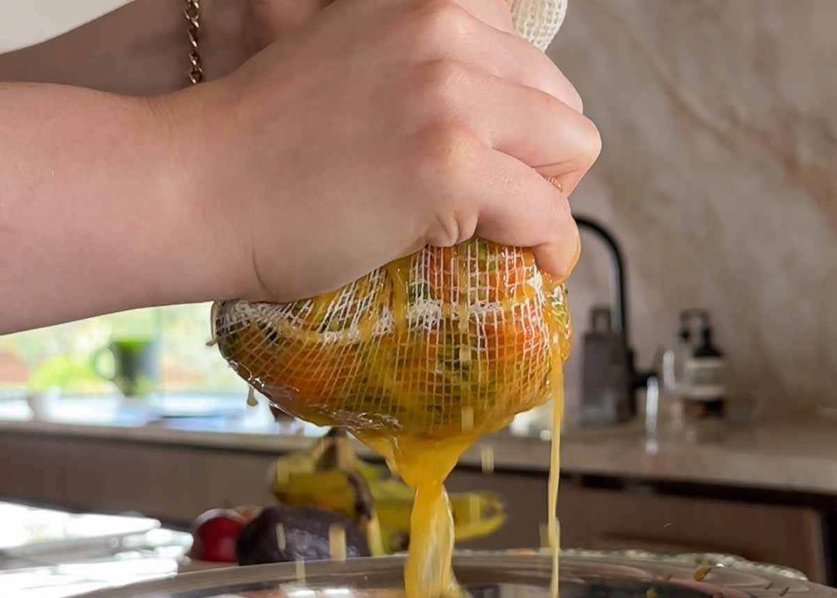Squeezing excess moisture from zucchini and carrot for crispy fritters