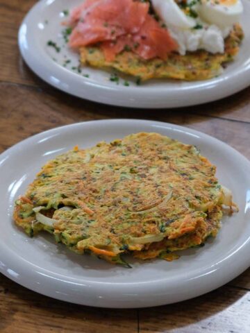 Stack of zucchini carrot and parmesan fritters showing texture and crisp edges