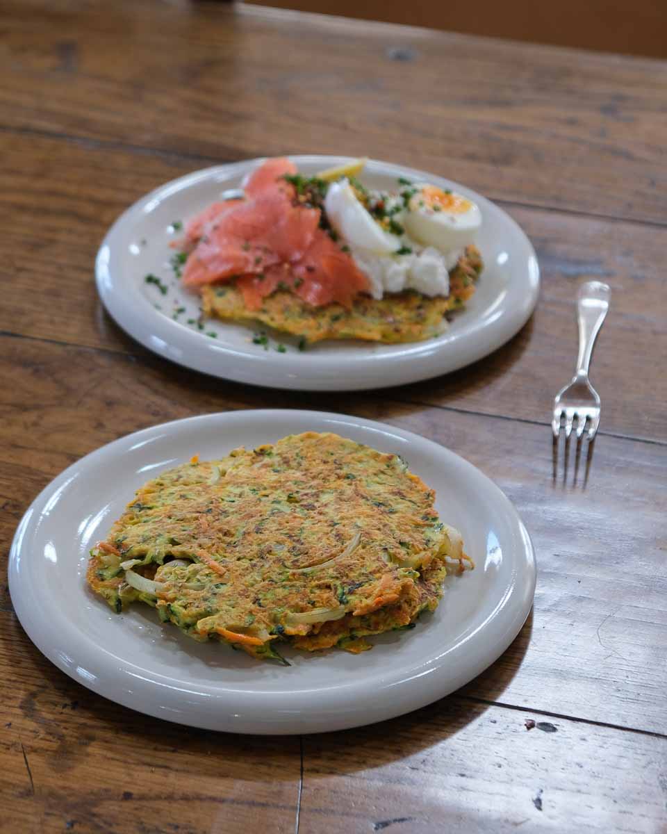 Stack of zucchini carrot and parmesan fritters showing texture and crisp edges