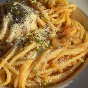 Close up of caramelised onion and anchovy spaghetti with glossy butter sauce