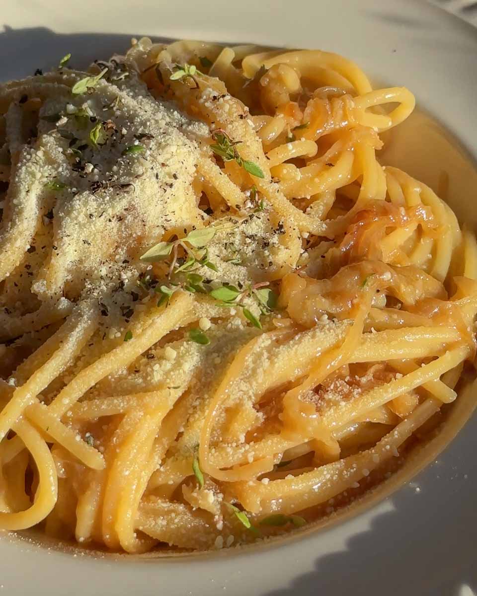 Caramelised onion and anchovy spaghetti finished with parmesan and black pepper