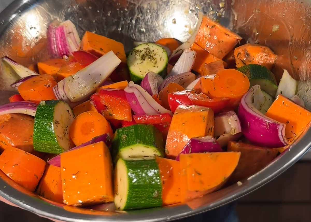 Chopped sweet potato, zucchini, capsicum and onion ready for roasting