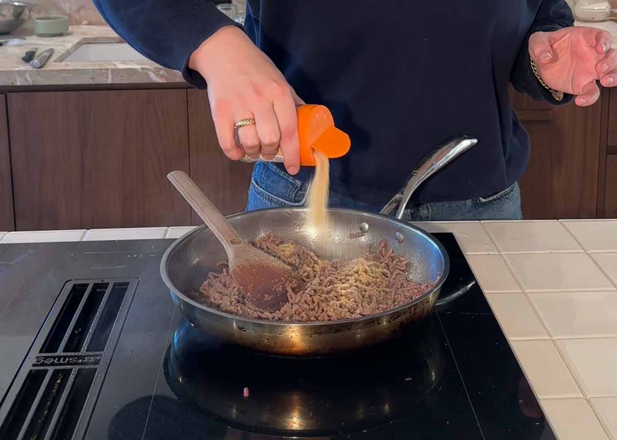 Beef mince browning in pan with spices for high protein meal prep