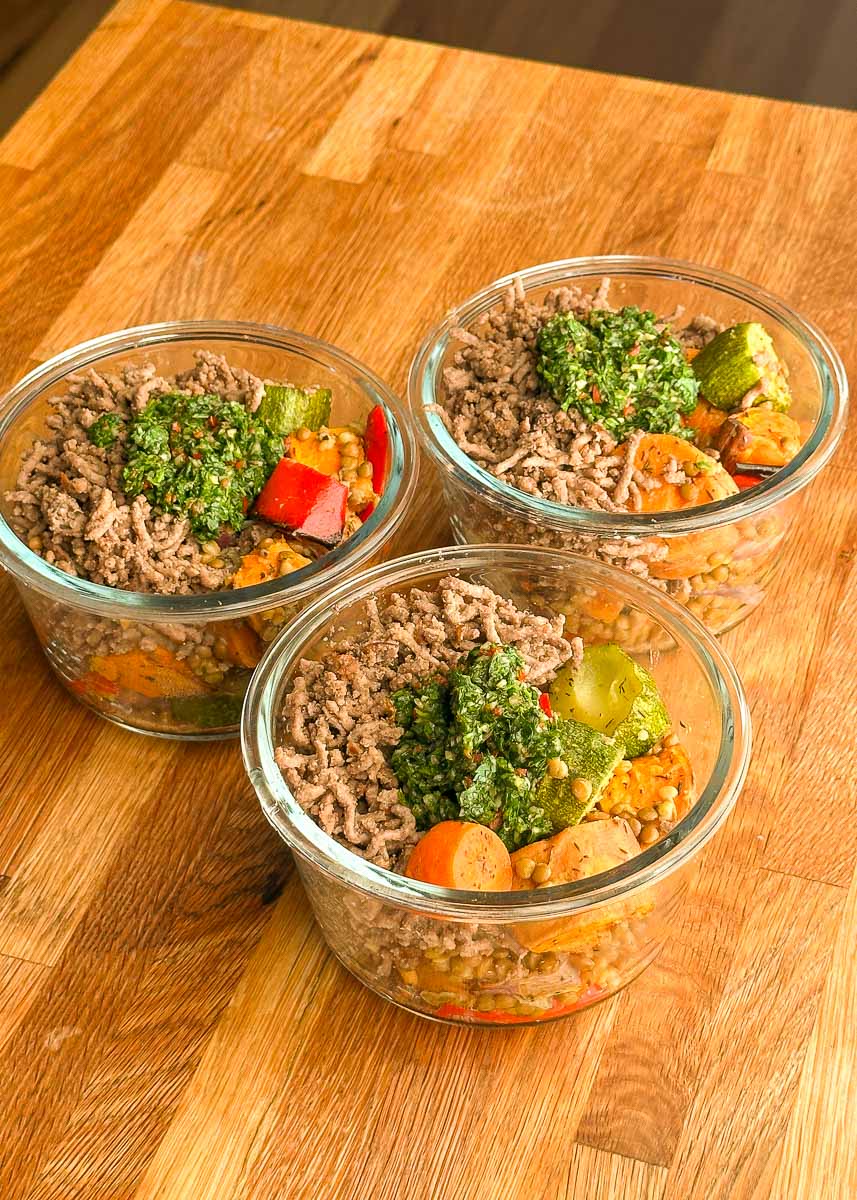 High protein beef mince and roasted vegetable bowls with chimichurri served in glass containers