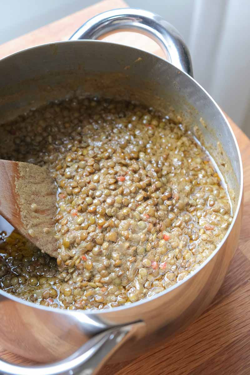 Lentils and aromatics cooking in pot for coconut lentil curry