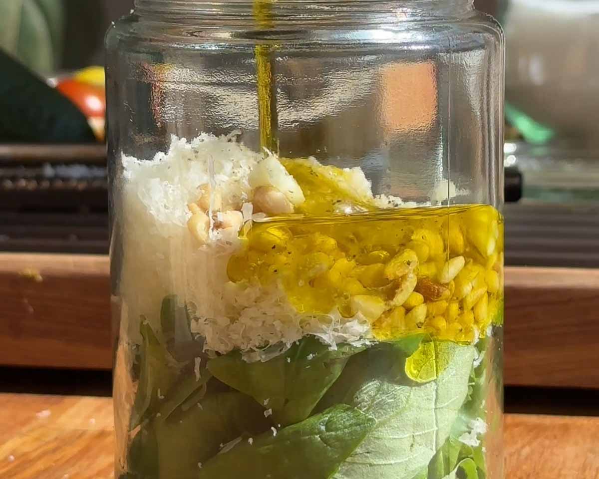 Fresh basil pesto being made for a tofucado toasted sandwich