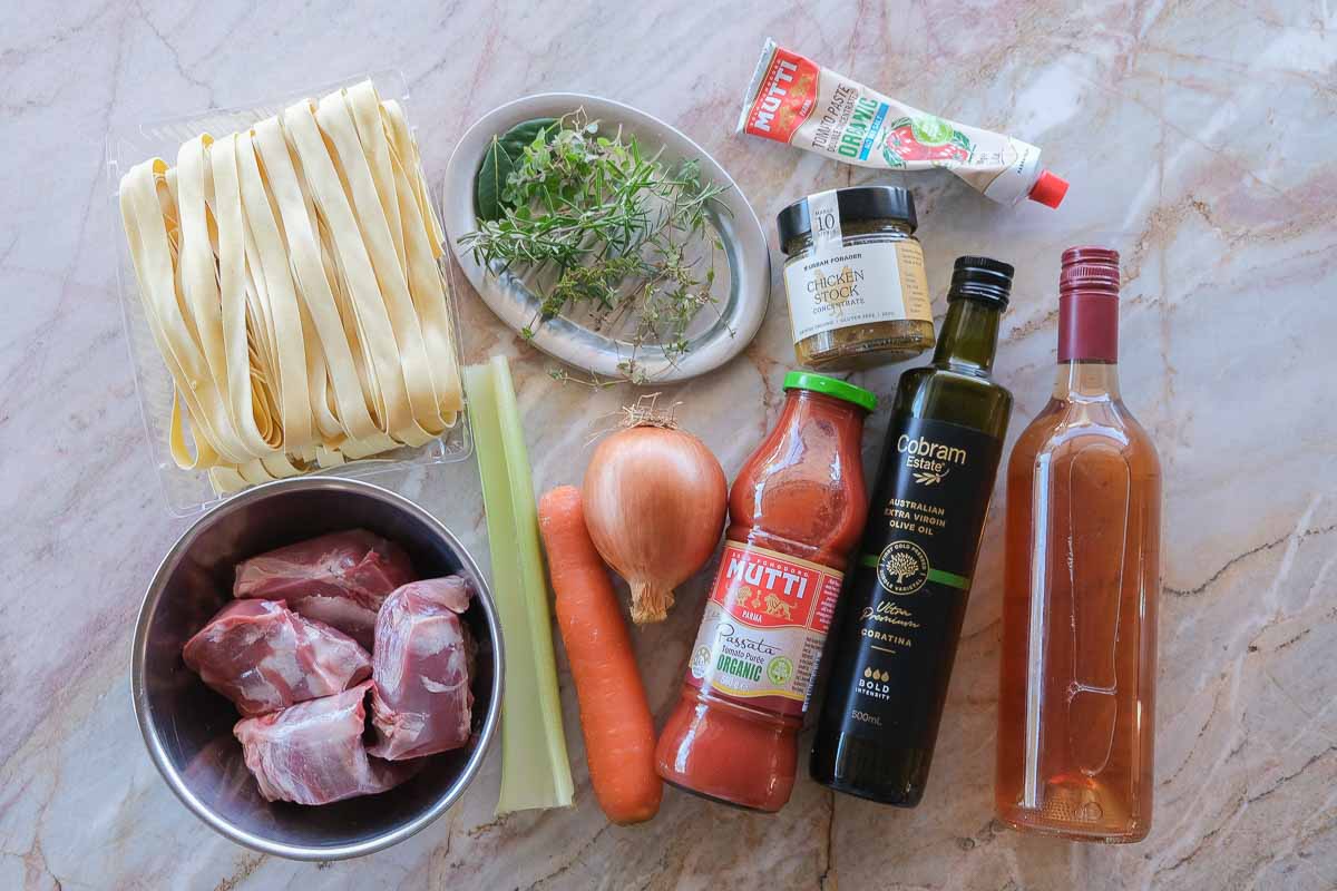 Ingredients for boneless lamb shank rosé ragu including lamb shank meat, rosé wine, herbs, vegetables and pappardelle