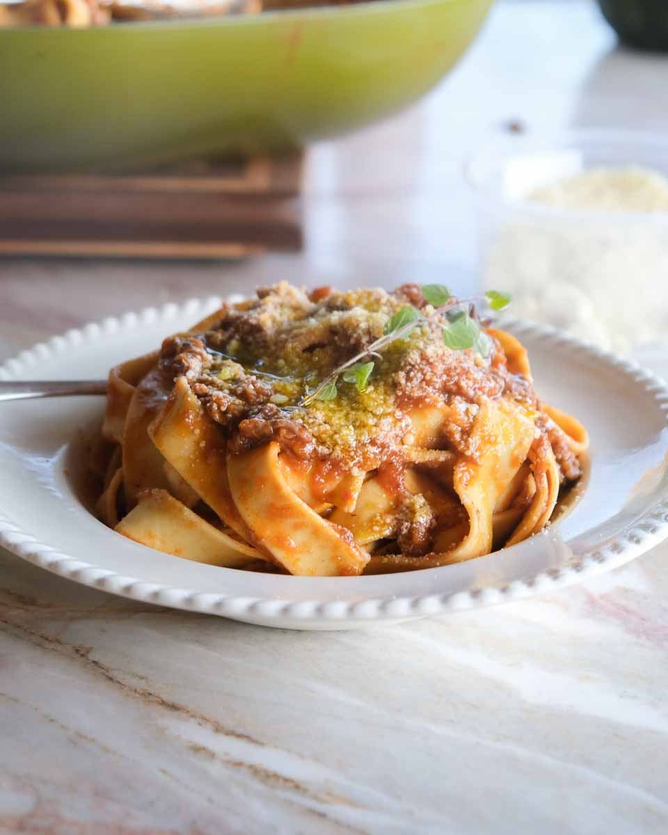 Served bowl of boneless lamb shank rosé ragu with parmesan and oregano