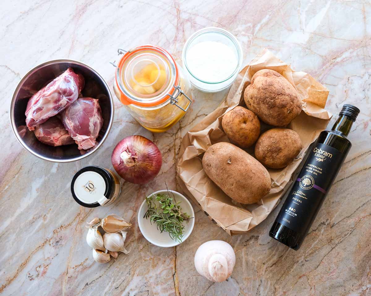 ngredients for preserved lemon boneless lamb shanks on a marble bench.