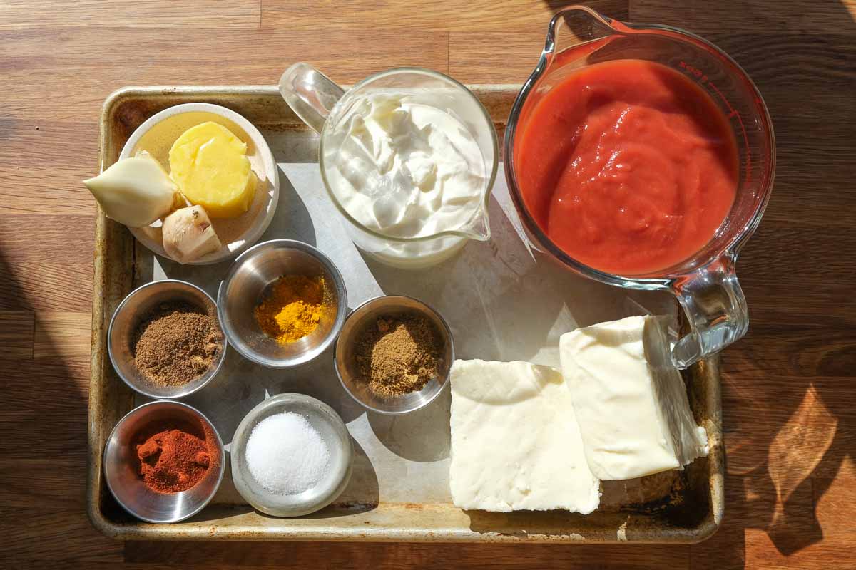 Ingredients for butter paneer one tray bake including paneer, passata, yoghurt and spices