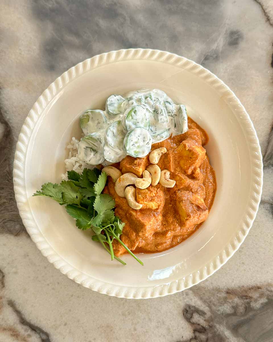 Butter paneer one tray bake served with garlic yoghurt cucumber salad