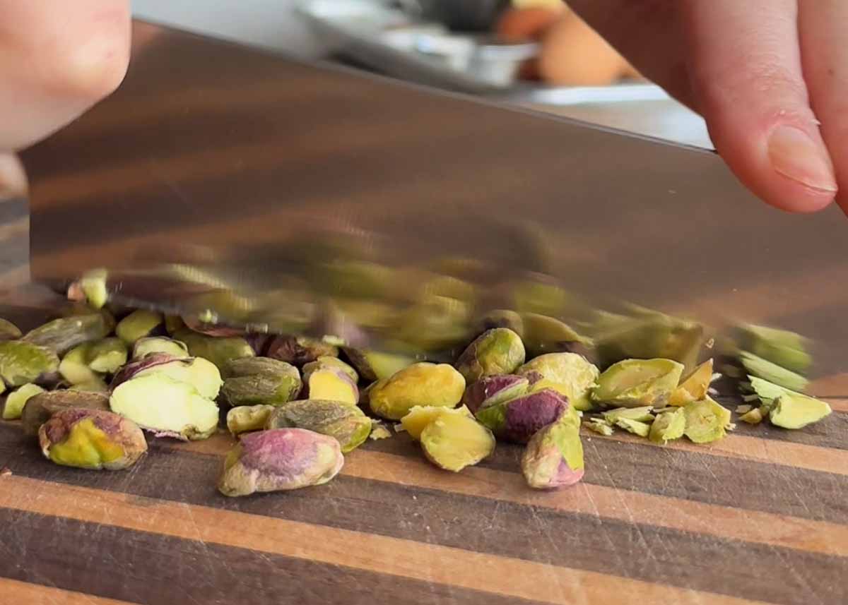 Chopping pistachios for spiced pistachio upside down cake.
