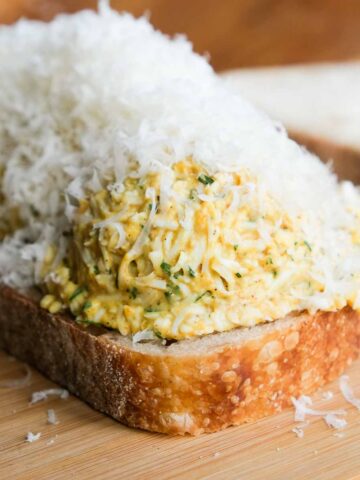 Golden crispy curried grated egg toastie with melted filling. feature image