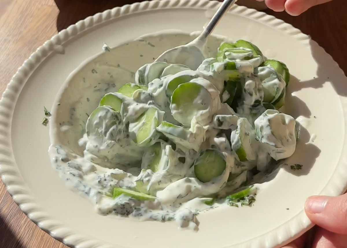 Close up of creamy cucumber yoghurt salad with herbs