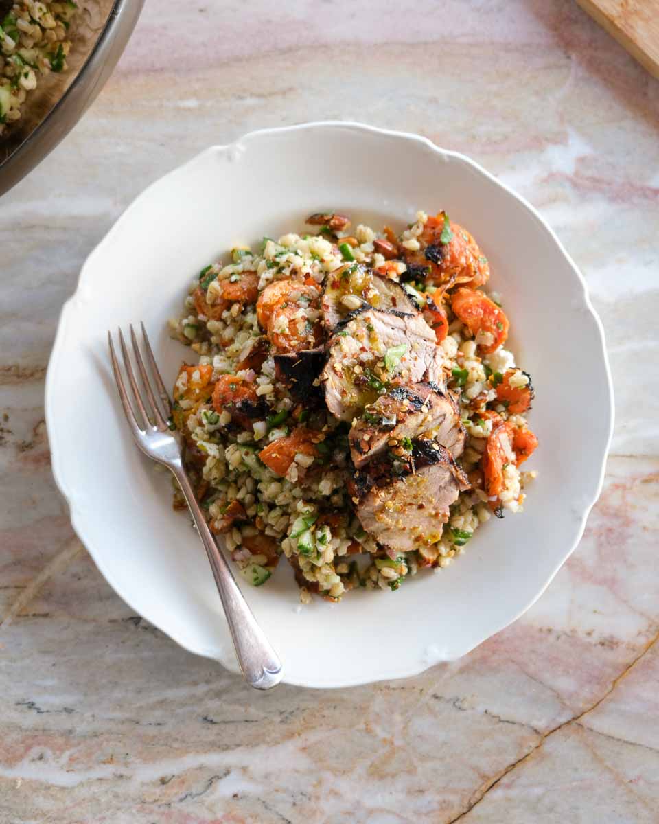 Warm smashed carrot salad with pearl barley, toasted almonds and sliced honey mustard pork tenderloin