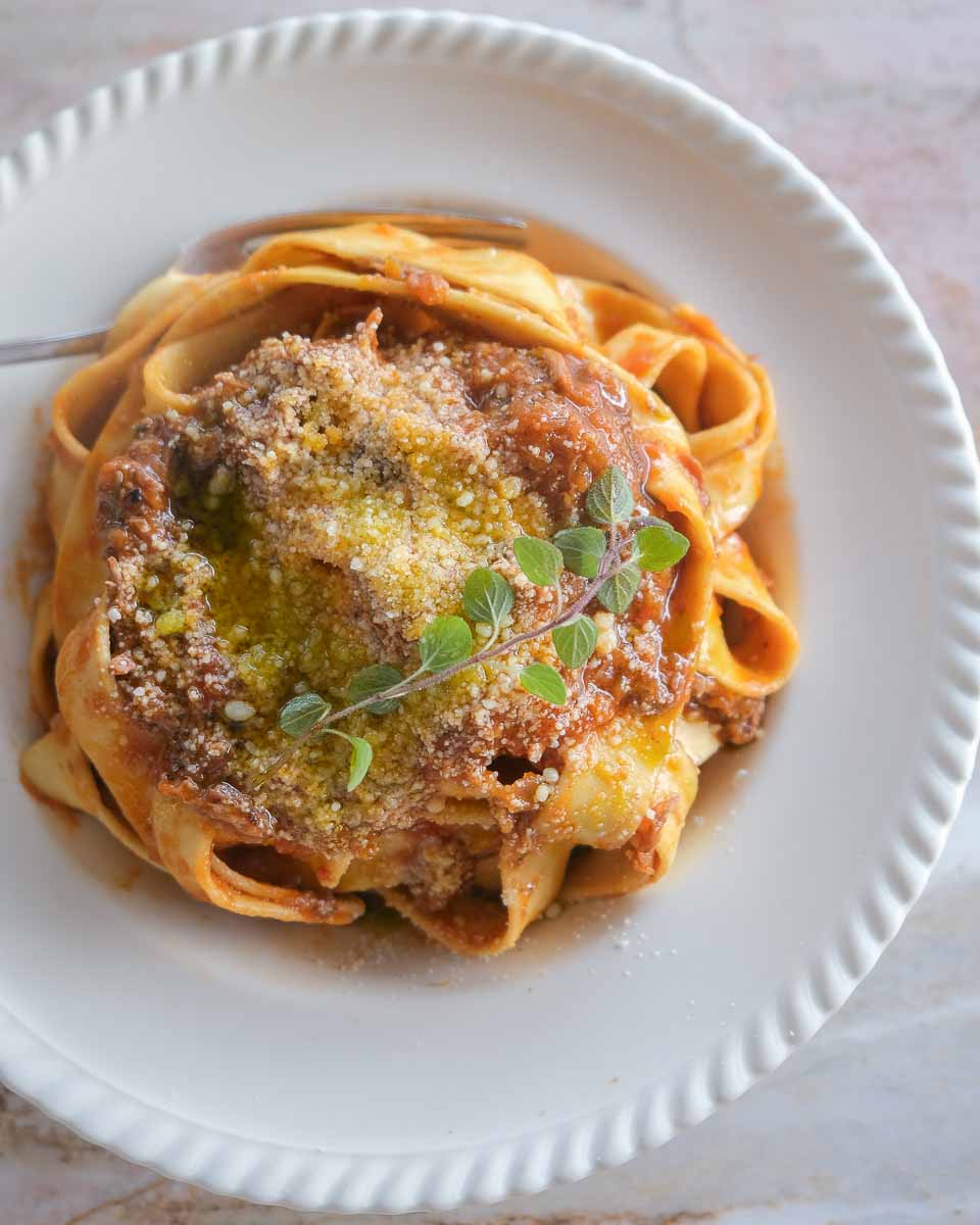 Plated boneless lamb shank rosé ragu with wide pappardelle ribbons