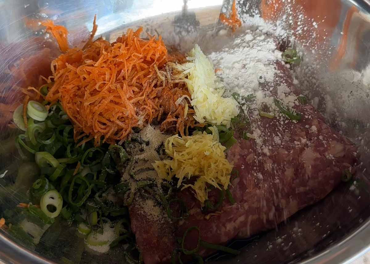 Pork mince mixed with grated carrot, ginger, garlic and spring onion for rice paper dumplings.