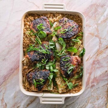 Sticky miso chicken cabbage rice bake served in a baking dish with ginger rice and spring onion.