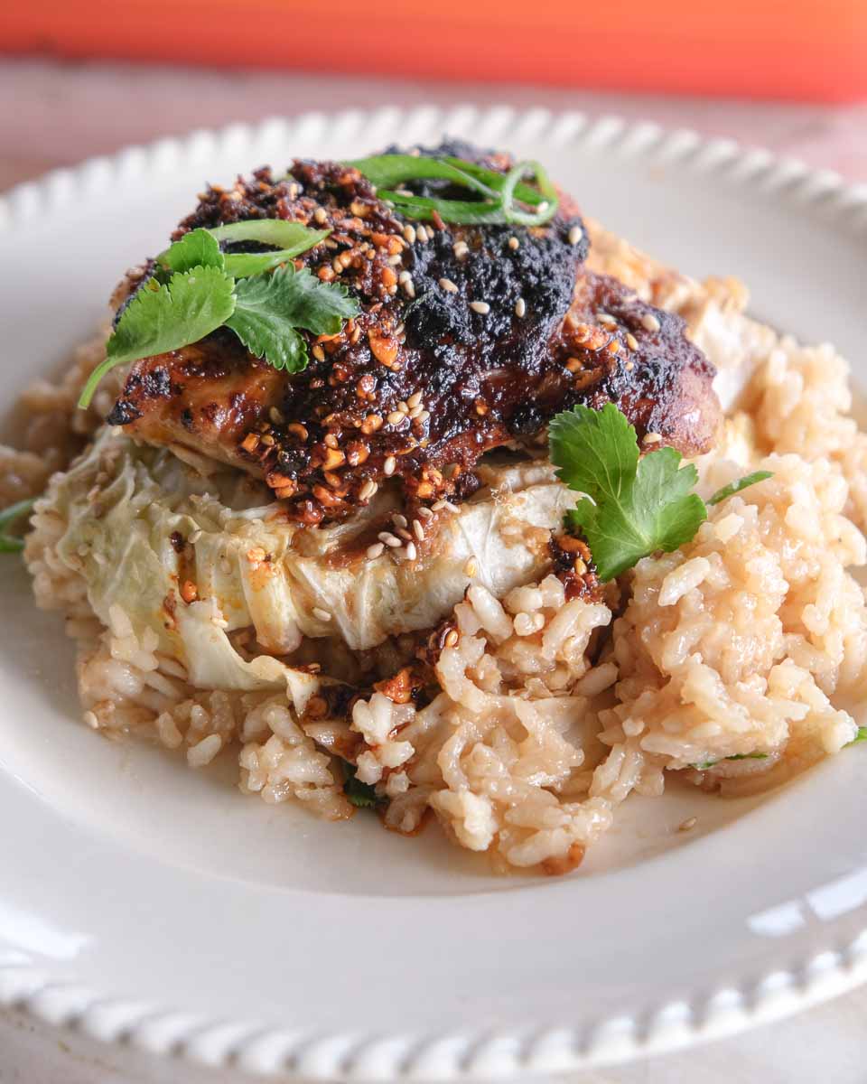 Bowl of miso chicken cabbage rice bake with tender cabbage, sticky chicken and sesame seeds.