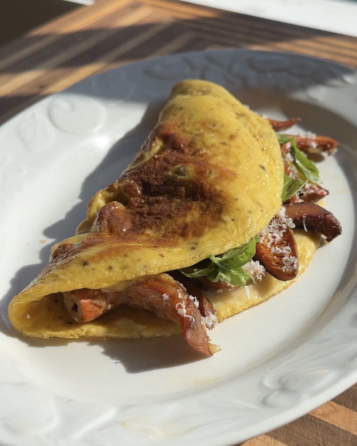pine mushroom omelette plated on white plate