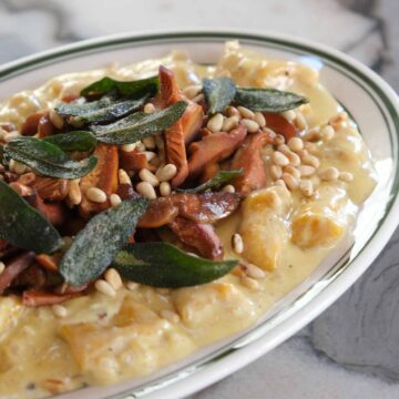 Creamy pumpkin gnocchi topped with crispy seared pine mushrooms, sage and toasted pine nuts