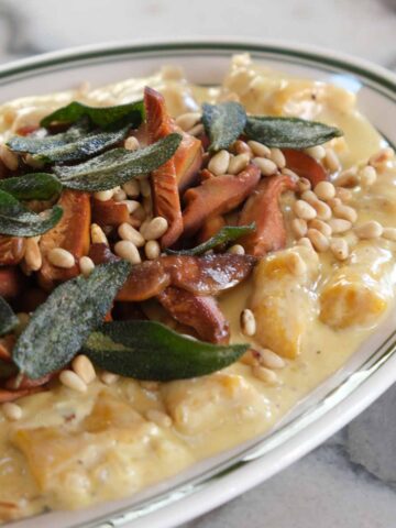 Creamy pumpkin gnocchi topped with crispy seared pine mushrooms, sage and toasted pine nuts