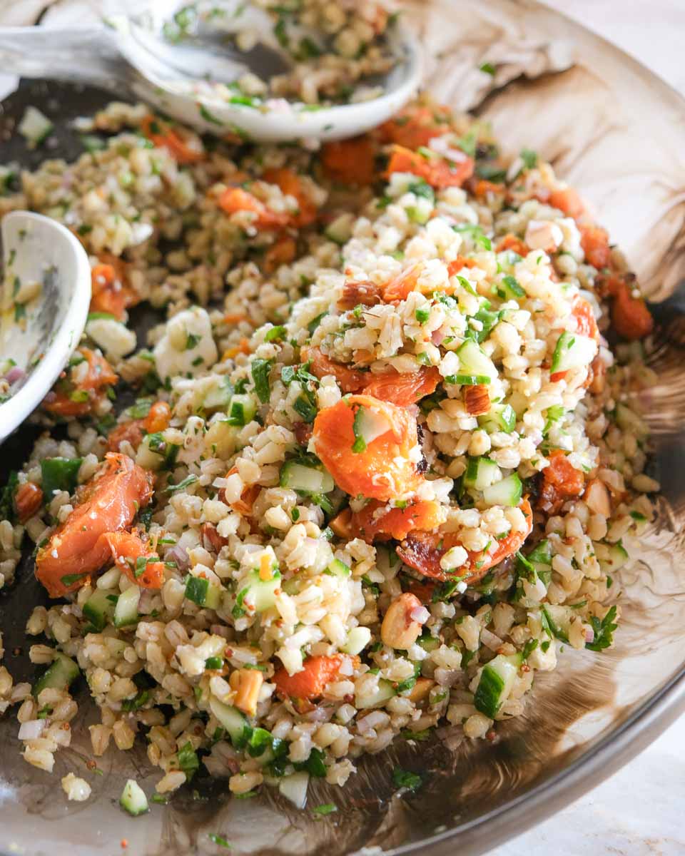 Side angle of smashed carrot and pearl barley salad with feta, parsley and honey mustard pork slices. honey-mustard-pork-smashed-carrot-salad-bowl.jpg Alt text: Warm smashed carrot salad with pearl barley, toasted almonds and sliced honey mustard pork tenderloin. Side angle of smashed carrot and pearl barley salad with feta, parsley and honey.