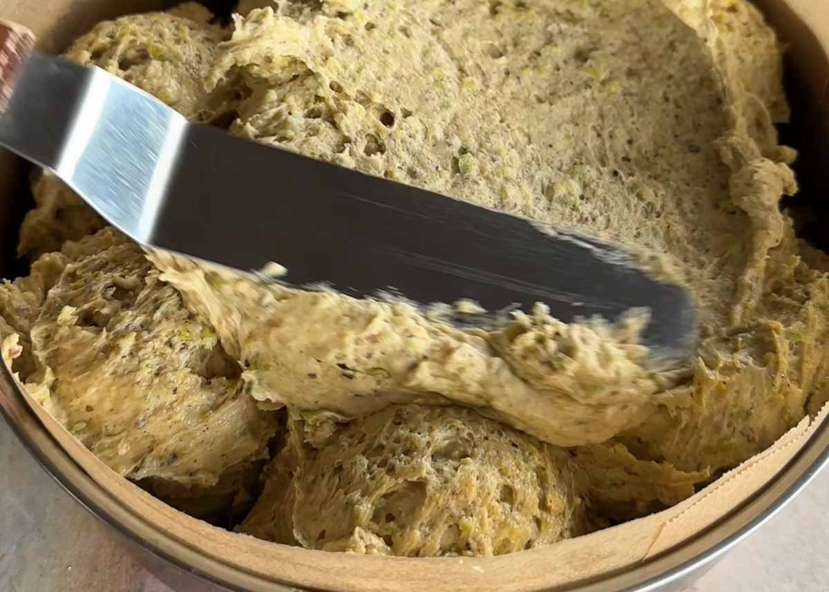 Thick spiced pistachio cake batter ready for baking.