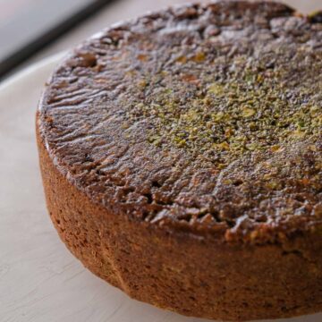 Spiced pistachio upside down cake with a caramelised pistachio topping and soft spiced crumb.