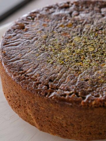 Spiced pistachio upside down cake with a caramelised pistachio topping and soft spiced crumb.