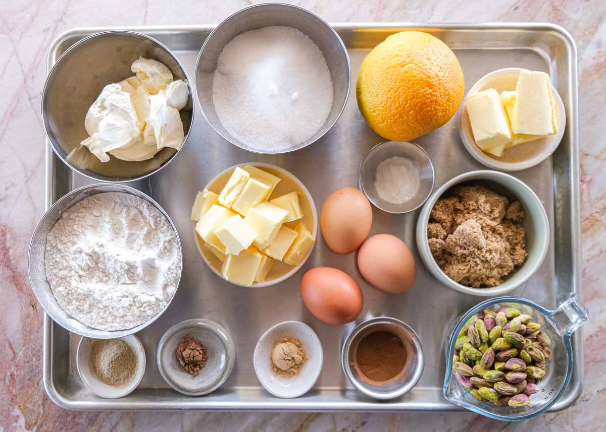 Ingredients for spiced pistachio upside down cake including pistachios, butter, eggs, sugar and spices.