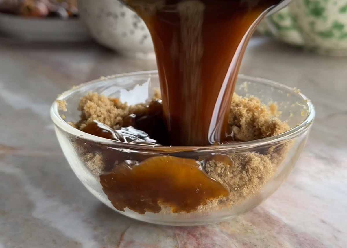 Brown butter being poured into orange sugar and spices for scroll filling.