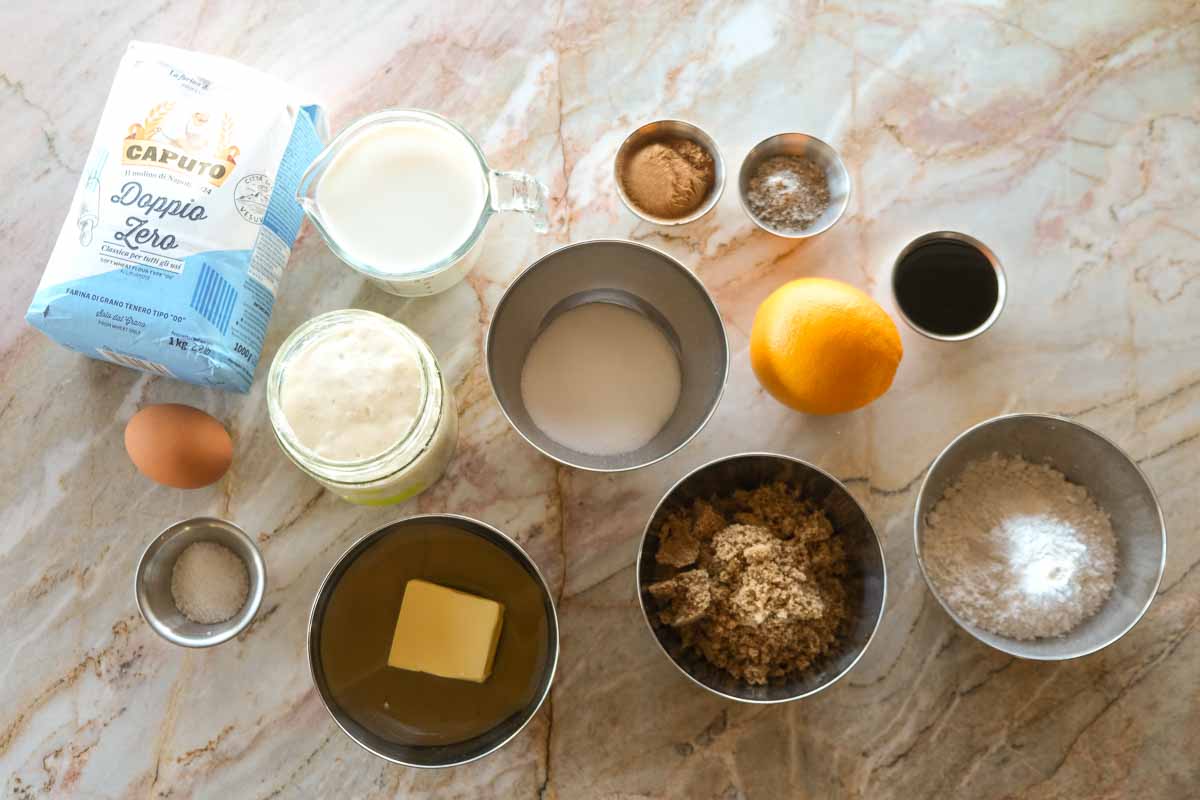 Ingredients for brown butter cardamom sourdough scrolls arranged on a bench before baking.
