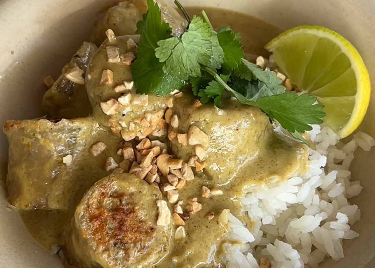Chicken Rice Paper Dumpling Green Thai Curry served with jasmine rice, toasted peanuts, coriander and lime.