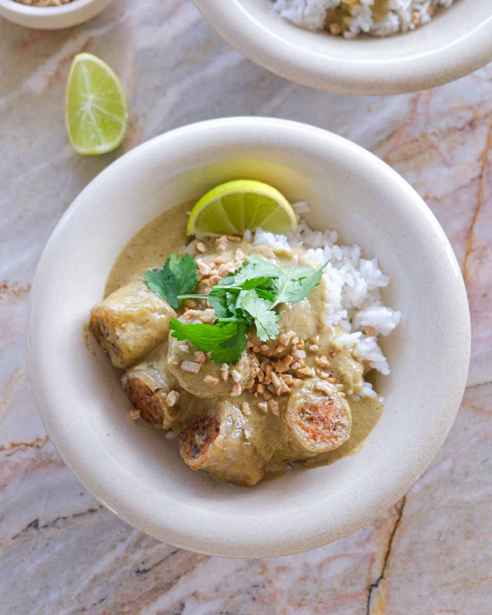 Chicken Rice Paper Dumpling Green Thai Curry served over jasmine rice with coriander, toasted peanuts and lime.