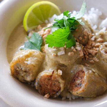 Feature image of crispy chicken rice paper dumplings in creamy green Thai curry sauce.