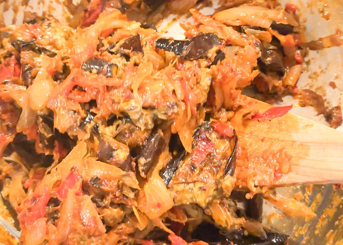Jammy eggplant, capsicum and onion filling cooking in a pan.