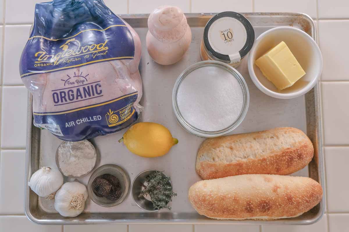 ingredients for truffle roast chicken and gravy roll including chicken, truffle, butter, thyme, salt, pepper, lemon, chicken stock and bread rolls