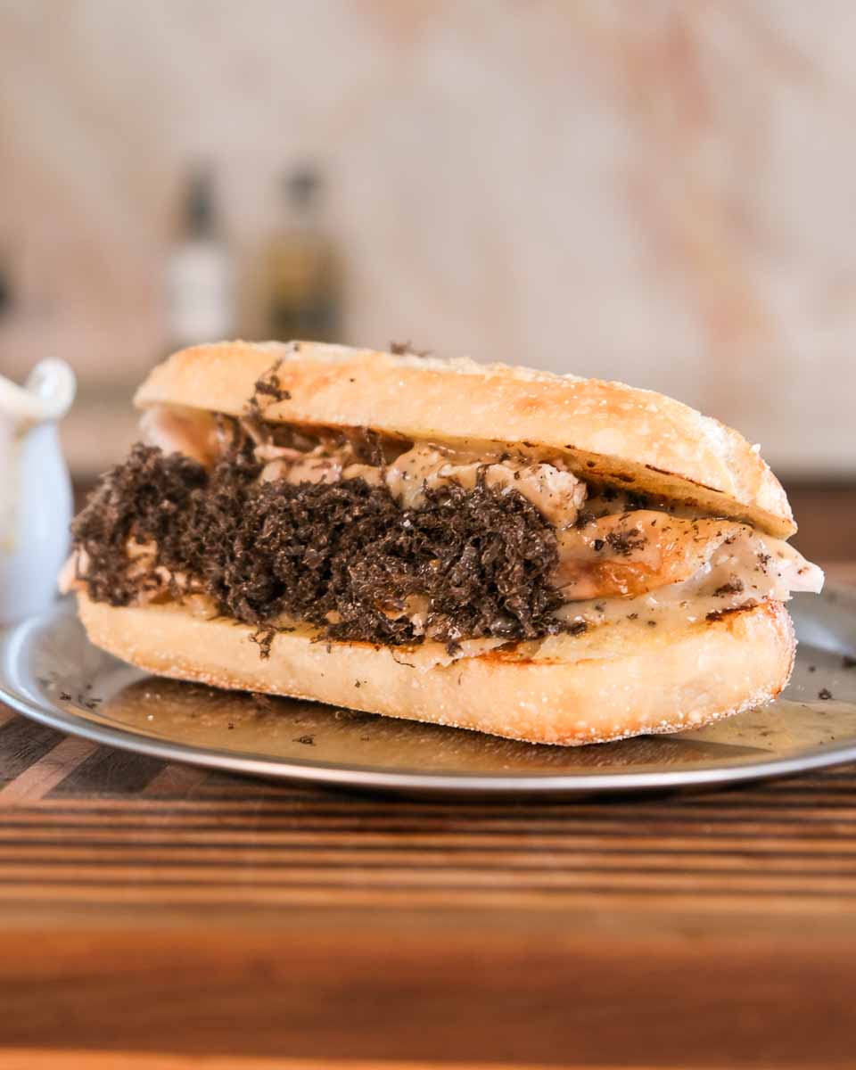 truffle roast chicken gravy roll plated on kitchen bench