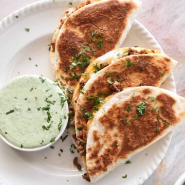 Beef tacos with melted cheese and jalapeño coriander yoghurt