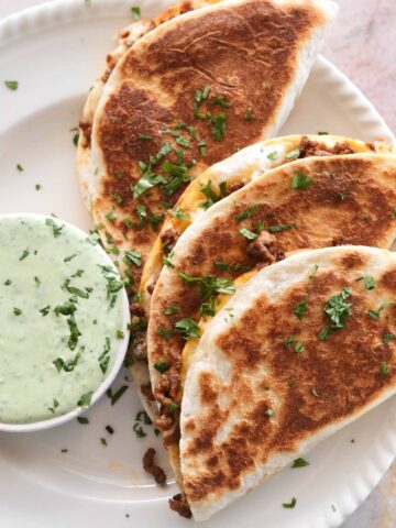Beef tacos with melted cheese and jalapeño coriander yoghurt