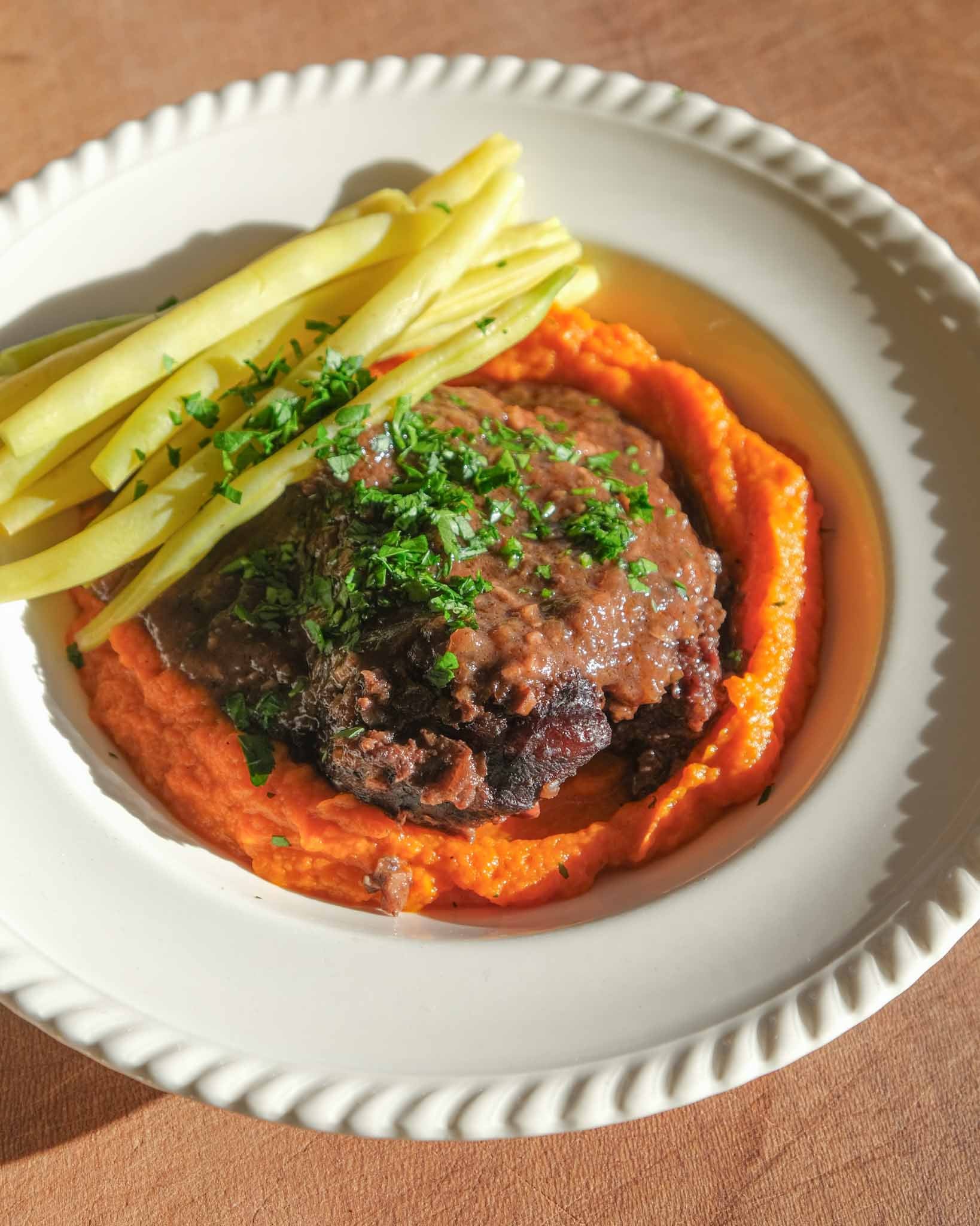 Braised beef cheek served with carrot purée, green beans and red wine sauce